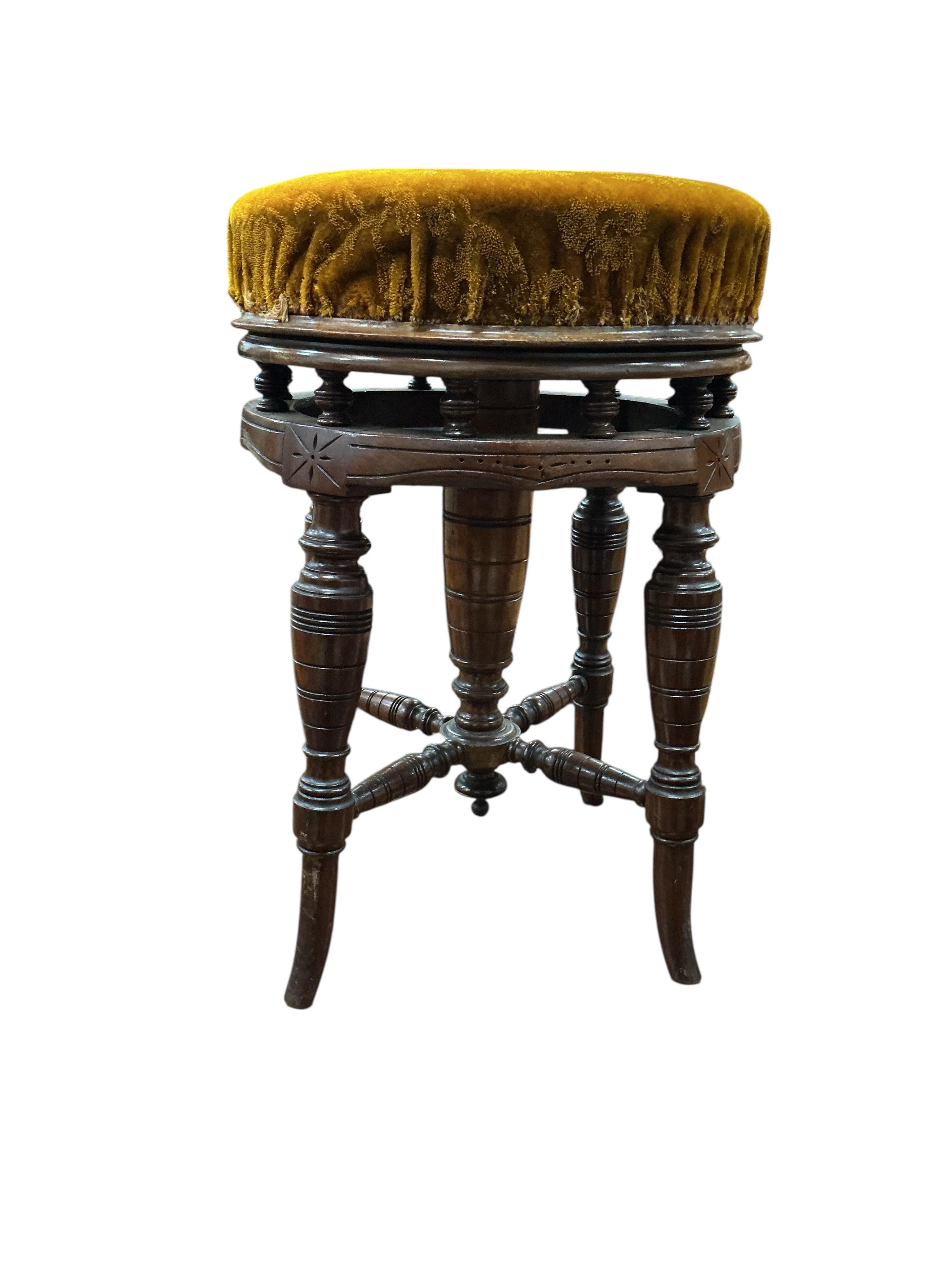 A late Victorian mahogany adjustable revolving piano stool